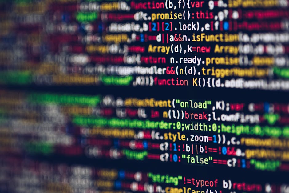 A close-up view of a laptop displaying a dark-themed code editor with lines of programming code visible on the screen. To the right of the laptop, there is a ceramic coffee mug with a glossy finish; t